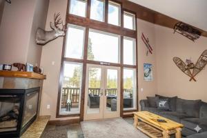 a living room with a couch and a fireplace at Kirkwood Mountainside Cabin & Cottage Deck wViews in Kirkwood