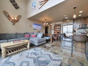 a living room with a couch and a table at Kirkwood Mountainside Cabin & Cottage Deck wViews in Kirkwood