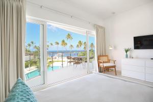 a bedroom with a view of the ocean at Destination Jelly Playa Coral Condo in Punta Cana