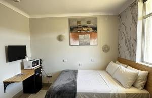 a hotel room with a bed and a tv at Perth City Motel in Perth