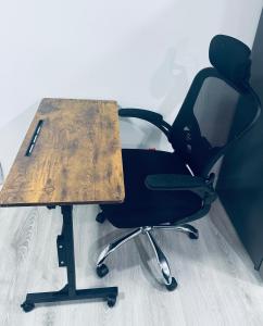 a desk with a chair and a wooden top at Maple Nest in Regina