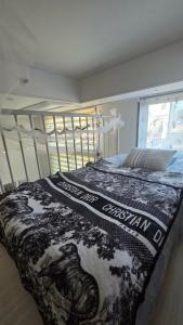 a bedroom with a bed with a black and white blanket at La Casa Verde in Seoul