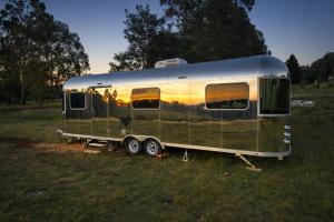 an old trailer parked in a field at One Life Glamping Caravan Rawson in Rawson +3 photos