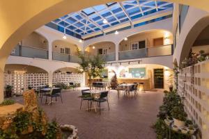 an indoor courtyard with tables and chairs in a building at TRANQUIL HOUSE in Lhasa