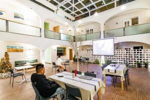 a man sitting at a table in a room with a screen at TRANQUIL HOUSE in Lhasa