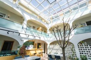 a building with a glass ceiling with a tree in the middle at TRANQUIL HOUSE in Lhasa