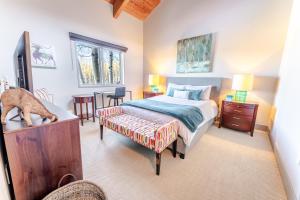 a bedroom with a bed and a dog standing on a dresser at Family Snowmass Getaway Minutes To Ski & Village - 229 #36 in Snowmass Village