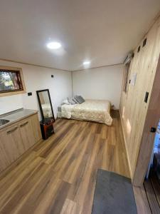 a bedroom with a bed and a wooden floor at Exclusive Montecarlos in Pidpid