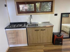 a kitchen with a sink and a stove in a room at Exclusive Montecarlos in Pidpid