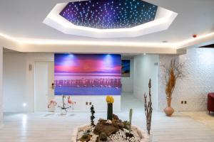 a living room with a large painting on the wall at Illampu Art Boutique Hotel in La Paz