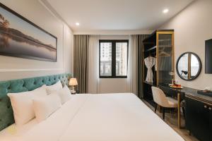 a bedroom with a large bed and a dressing room at San Hotel & Spa in Hanoi +53 photos