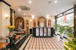 a living room with a fireplace in the middle at San Hotel & Spa in Hanoi