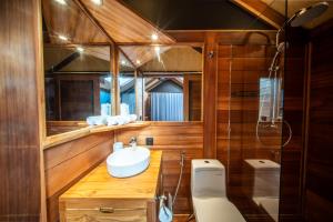 a bathroom with a sink and a toilet and a mirror at Sokkool Coliving and Coworking - Near Berawa Beach in Canggu