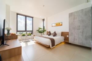 a bedroom with a bed and a tv in it at Quy Nhon Sea Hotel in Quy Nhon +53 photos