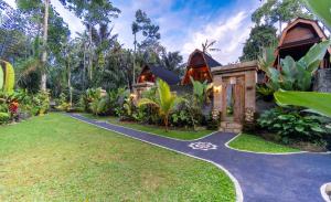 a house with a garden and a driveway at Jungle Forest Villa Ubud by The Travel Ubud Bali in Ubud