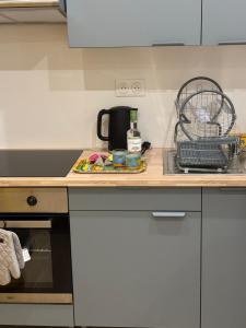 a kitchen counter with a coffee maker and a drying rack at Bungalow BAO in Fort-de-France