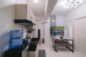 a kitchen with a large blue container on the counter at Instaworthy 1BR unit at Royal Oceancrest Mactan in Mactan Island