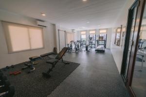 a gym with several exercise bikes in a room at Instaworthy 1BR unit at Royal Oceancrest Mactan in Mactan Island