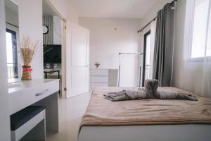 a white kitchen with a bed in a room at Instaworthy 1BR unit at Royal Oceancrest Mactan in Mactan Island +29 photos