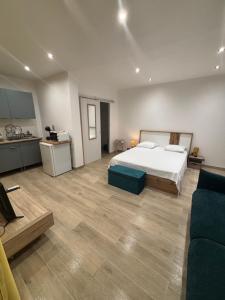 a large bedroom with a bed and a kitchen at Bungalow BAO in Fort-de-France