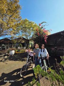 a group of three people standing next to their bikes at Follow Me designed B&B in Dongshan