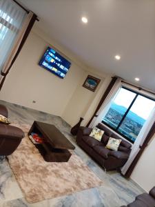 a living room with couches and a table and windows at RoofTop in Kollpa