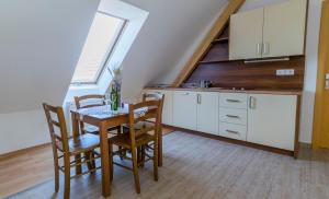 a kitchen with a table and chairs in a room at Szlovén Mintagazdaság in Felsőszölnök