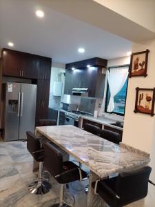 a kitchen with a large marble table and chairs at RoofTop in Kollpa