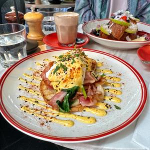 a plate of food with eggs on a table at Bounce Melbourne in Melbourne