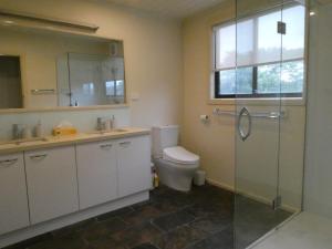 a bathroom with a toilet and a glass shower at Absolute beach front stunning views day and night in Cape Bridgewater +12 photos