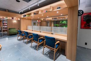 a waiting room with blue chairs and a long table at Gran Custama Ueno in Tokyo