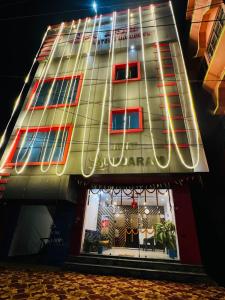 a building with a sign on the side of it at Hotel Sundaram in Deoghar