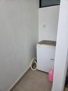 a small laundry room with a washer and dryer at D'BROGA HILL Homestay in Kampong Solok +11 photos