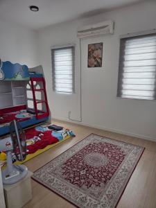 a bedroom with a bed and a rug on the floor at D'BROGA HILL Homestay in Kampong Solok