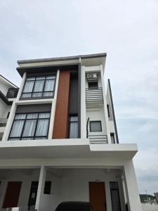 a white building with balconies on it at D'BROGA HILL Homestay in Kampong Solok