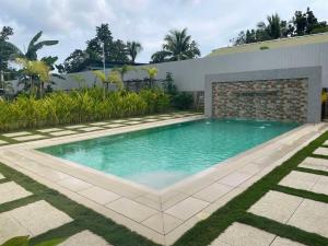 a swimming pool in the backyard of a house at BC Lodge in Puerto Princesa City