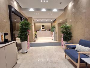 a lobby with potted plants and a waiting room at Hotel Hariu in Gwangju