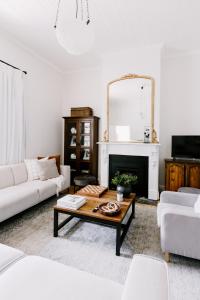 a living room with a coffee table and a mirror at Oakview Country House Maffra in Maffra