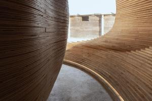 a wooden spiral staircase in a building at Sanamane in Naoshima +33 photos