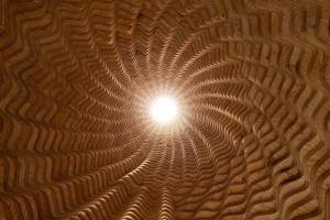a ceiling with a light in the middle at Sanamane in Naoshima