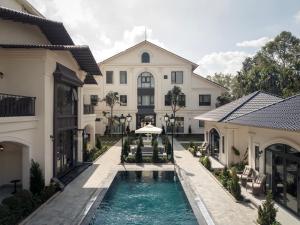 an exterior view of a house with a swimming pool at Narci Resort Tam Coc in Ninh Binh