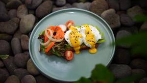 a plate of food with eggs and vegetables on it at Del Cielo Villa Jimbaran in Jimbaran