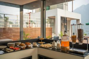 a counter with some food and drinks on it at Perfectstayz Premium Kaashin - Ganga View Rooftop Cafe in Varanasi