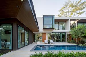 an external view of a house with a swimming pool at Cicada Estate in Ban Mae Pu Kha