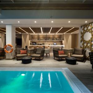 
a living room filled with furniture and a pool at Catalonia Giralda in Seville
