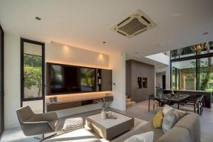 a living room with a couch and a table at Cicada Estate in Ban Mae Pu Kha