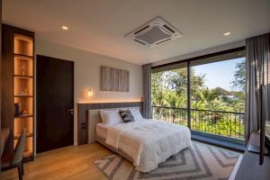 a bedroom with a bed and a large window at Cicada Estate in Ban Mae Pu Kha +106 photos