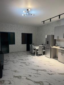 an empty kitchen and dining room with a table and chairs at Remember Me B&B in Dilijan