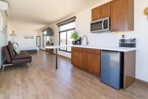 a kitchen with a counter and a chair in a room at Flor de Garambullo, Valle de Guadalupe in Valle de Guadalupe