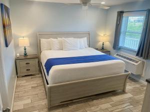 a bedroom with a large bed and two night stands at Beachgate Condo Suites and Hotel 514 condo in Port Aransas